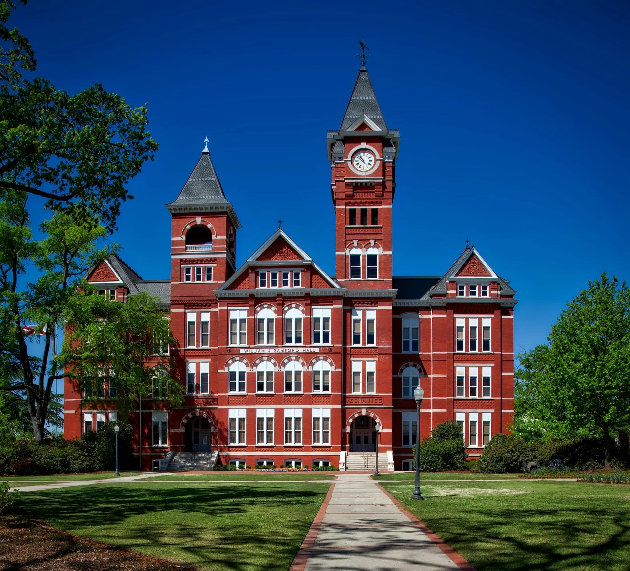 College campus with historic buildings and students walking